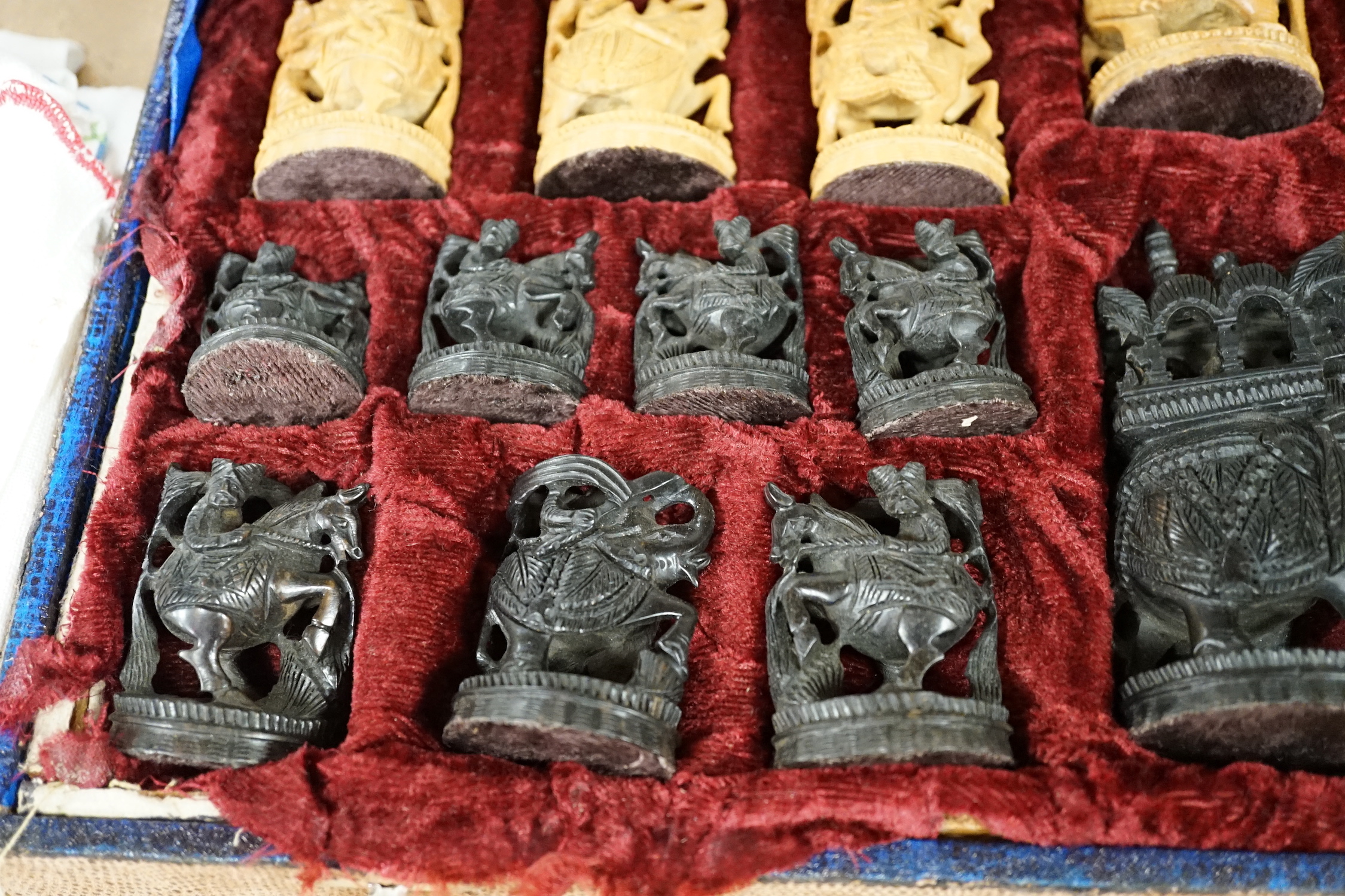 A cased Indian sandalwood and ebony figural chess set, case 50.5cm wide